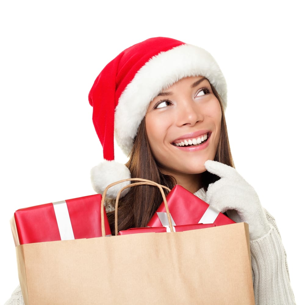 [Woman in Santa hat with bag of gifts]